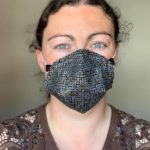 Emma wearing one of her custom made masks. The design is black with gold and silver circles