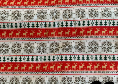 christmas print with raindeer snowflakes trees red white and gold